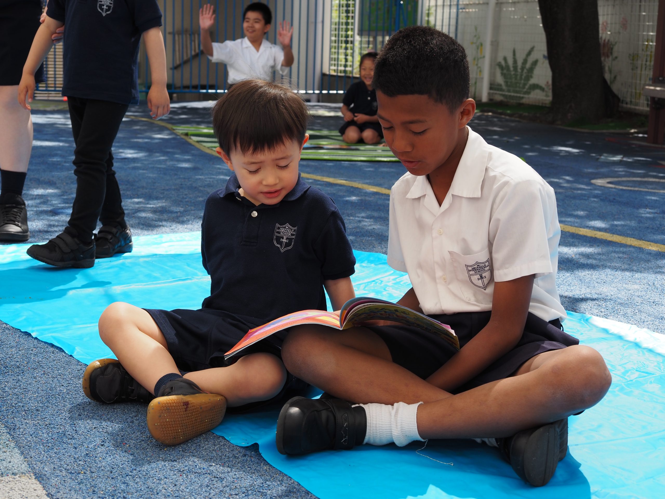 St. Michael's students reading together in the school playground